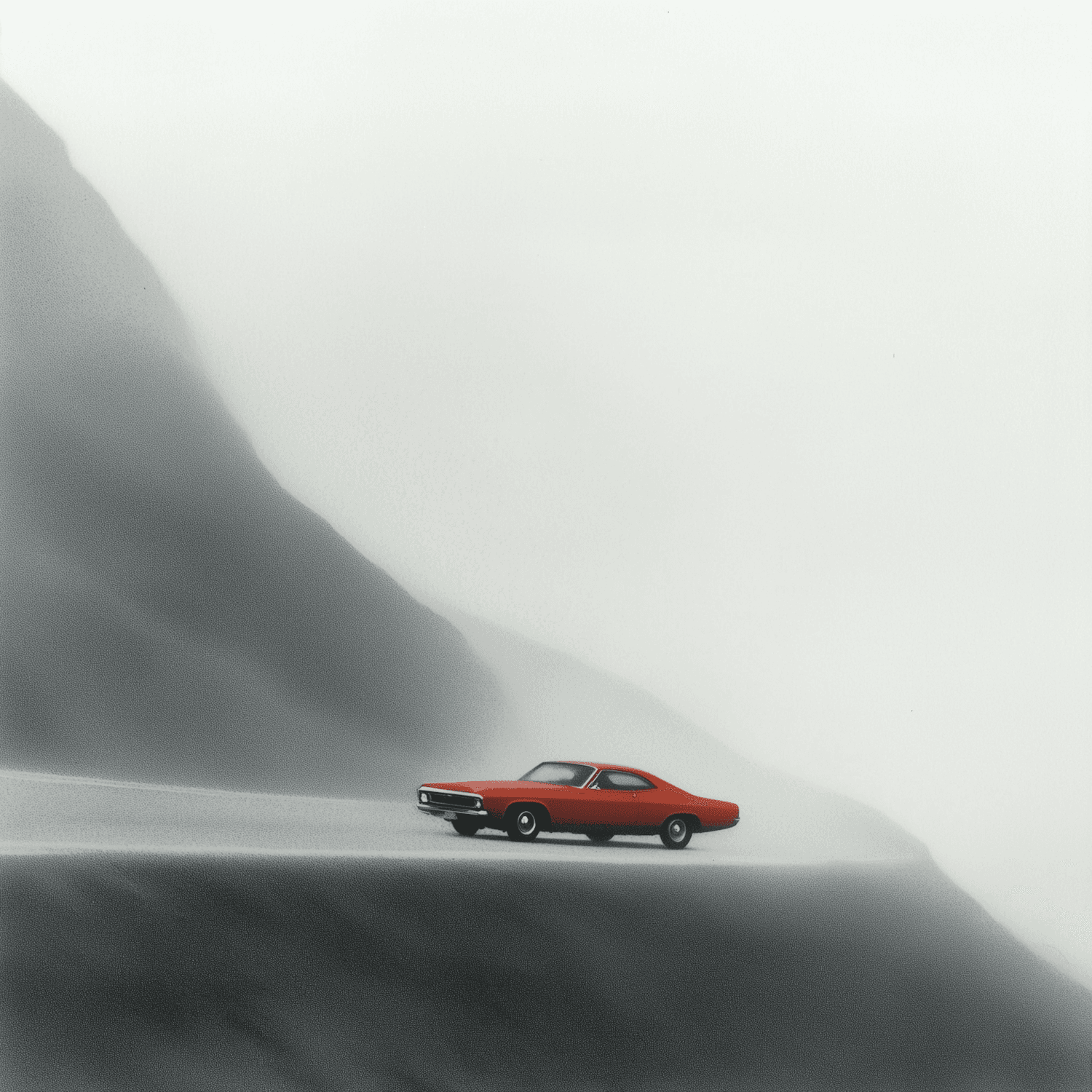 Red classic coupe on a mountain road surrounded by fog